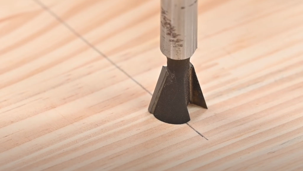 Fraise à queue d’aronde centrée sur l’axe d’une rainure à l’aide d’un gabarit de défonceuse